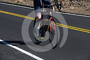 Cyclist on the road. Biker riding a sport track bikeÂ on asphalt road.